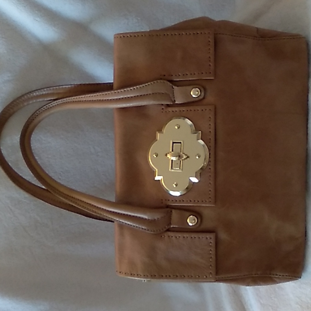 Cynthia Rowley brown genuine leather tote with striking gold hardware.
